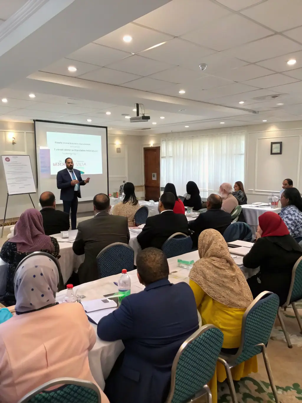 A diverse group of Indian professionals participating in a leadership workshop, actively engaging in team-building exercises and discussions.